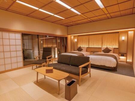 【茶寮露天風呂付客室：朝日】御影石の楕円形露天風呂（和洋室）