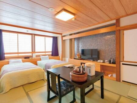 畳にベッドがあり落ち着いた雰囲気の和モダンベッド付客室一例