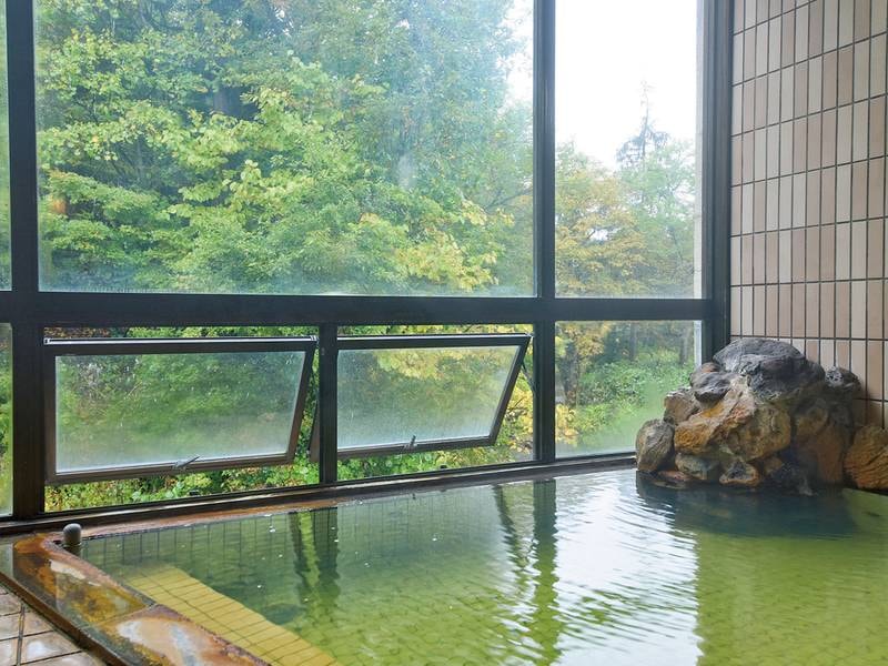 【大浴場】外に緑を眺め、清流のせせらぎが聞こえる、自慢のお風呂。広がる自然の風景とお湯の温かさに、身も心もゆだね、ゆっくりとおくつろぎください